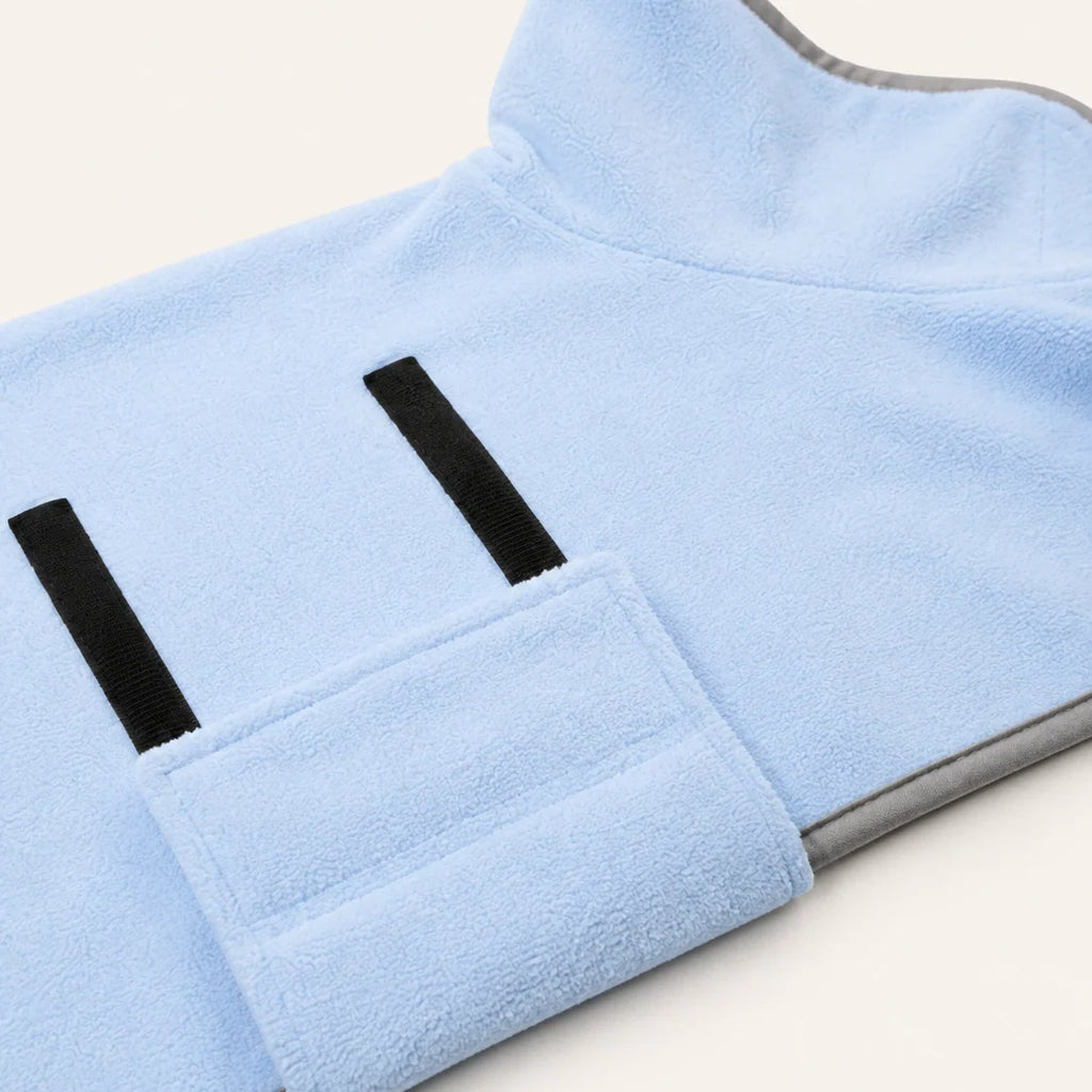 Close-up of the sky-blue Zoomie Robe absorbent fabric and adjustable closure